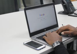 person typing on gray and black HP laptop