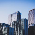 white and blue glass walled high rise building