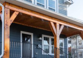 Newly restored single-family home with beautiful cedar wood beams and black metal railings.