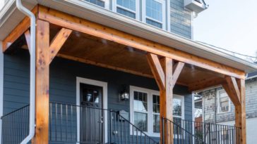 Newly restored single-family home with beautiful cedar wood beams and black metal railings.