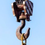 hook of a crane against a blue sky