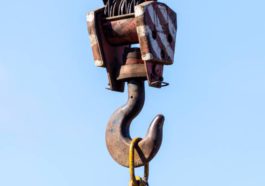 hook of a crane against a blue sky