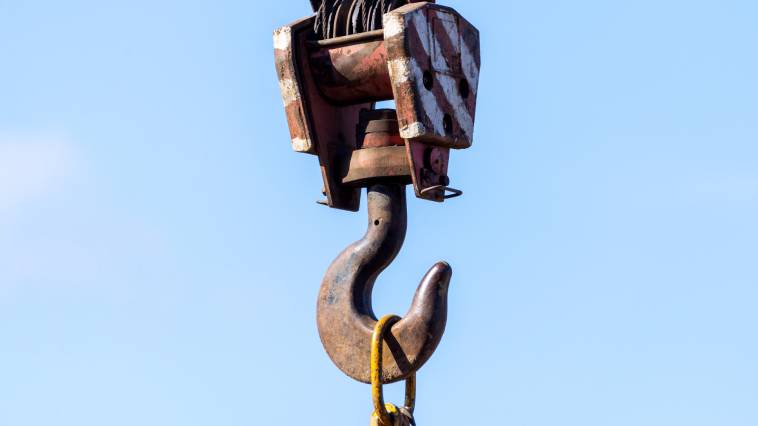 hook of a crane against a blue sky