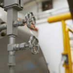 Water pumps in a boiler room used in commercial settings to help circulate water throughout the building.