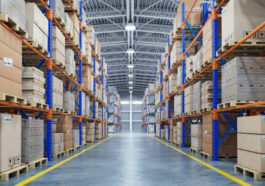 An organized warehouse building entire of boxes and materials stacked up towards the ceiling, with an industrial background.